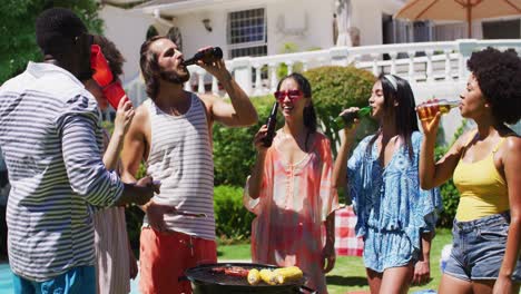 diverse group of friends having barbecue and drinking beer at a pool party