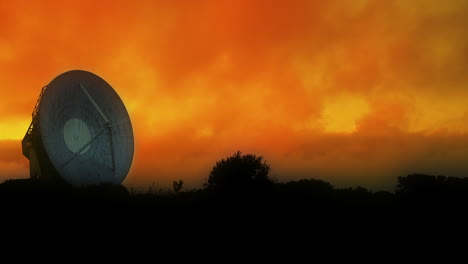 vibrant orange red sunset clouds moving slowly over a large satellite array