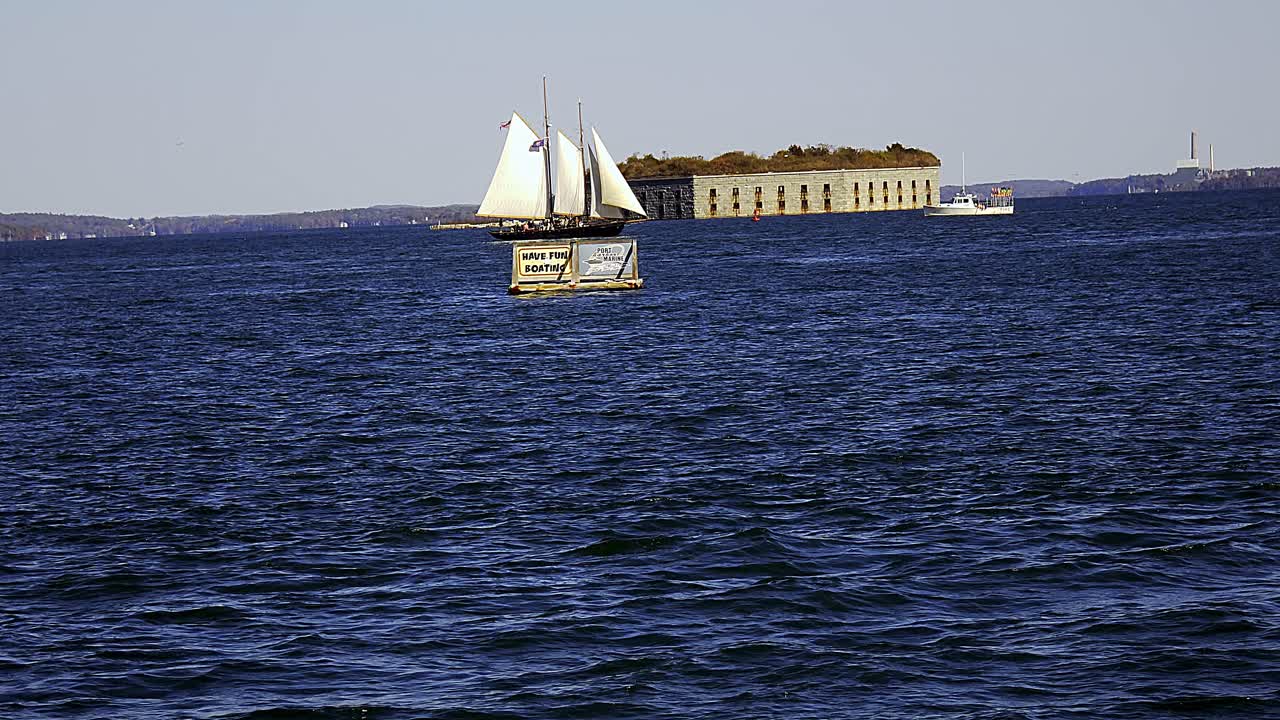 Historical Fort Gorges and sailboat in Casco Bay near Portland, Maine
