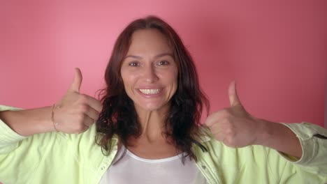 woman smiling and giving a thumbs up