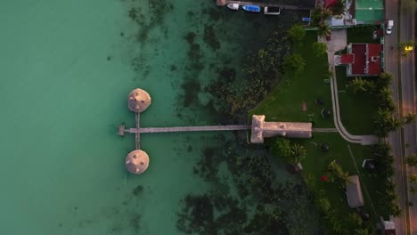 Aerial-view-above-piers-in-the-Bacalar-village,-Mexico---cenital,-drone-shot