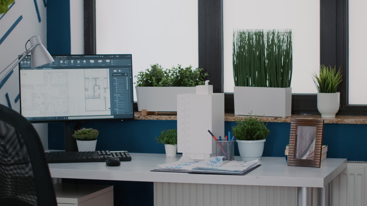 Interior of a modern office space with computer and plants
