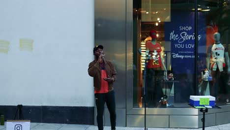 performer singing outside a shopping store