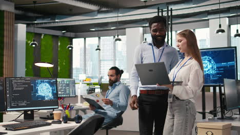 junior dev and colleague in office reviewing ai system metrics