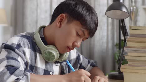 teenager studying at home, yawning