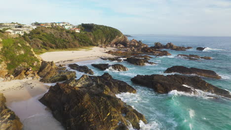 Waves-crashing-against-rocky-New-South-Wales-beach,-Forster-Australia,-aerial