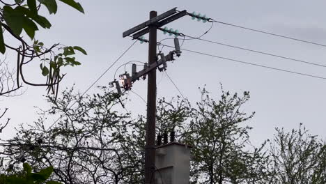 electric wires cables and pole, power lines and electrical equipment connector conductor in fire burning, electricity short circuit danger and risk due to technical problem after storm