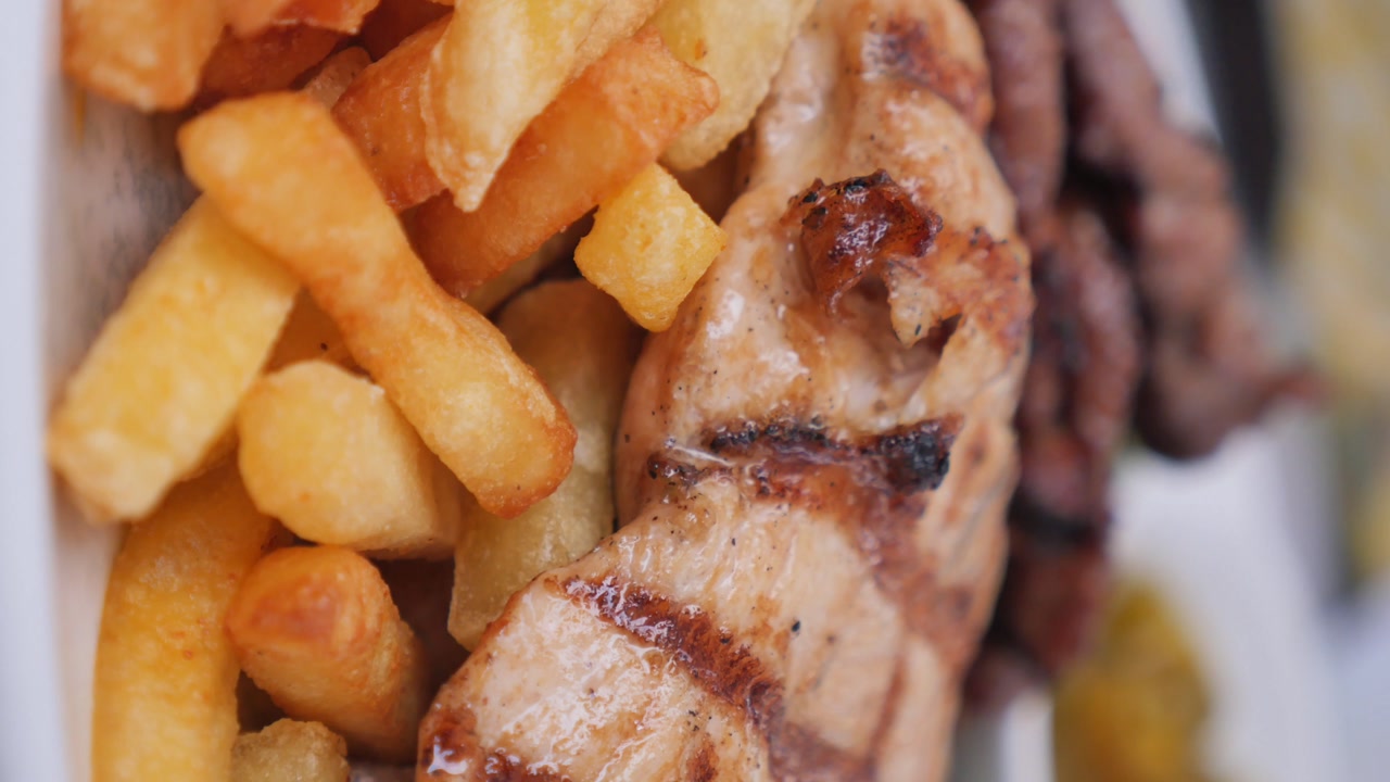 Delicious Grilled Chicken Breast Served with Crispy French Fries