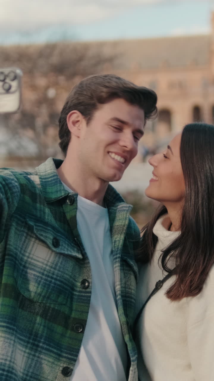 Happy young young pair man and woman looking at camera while standing on bridge