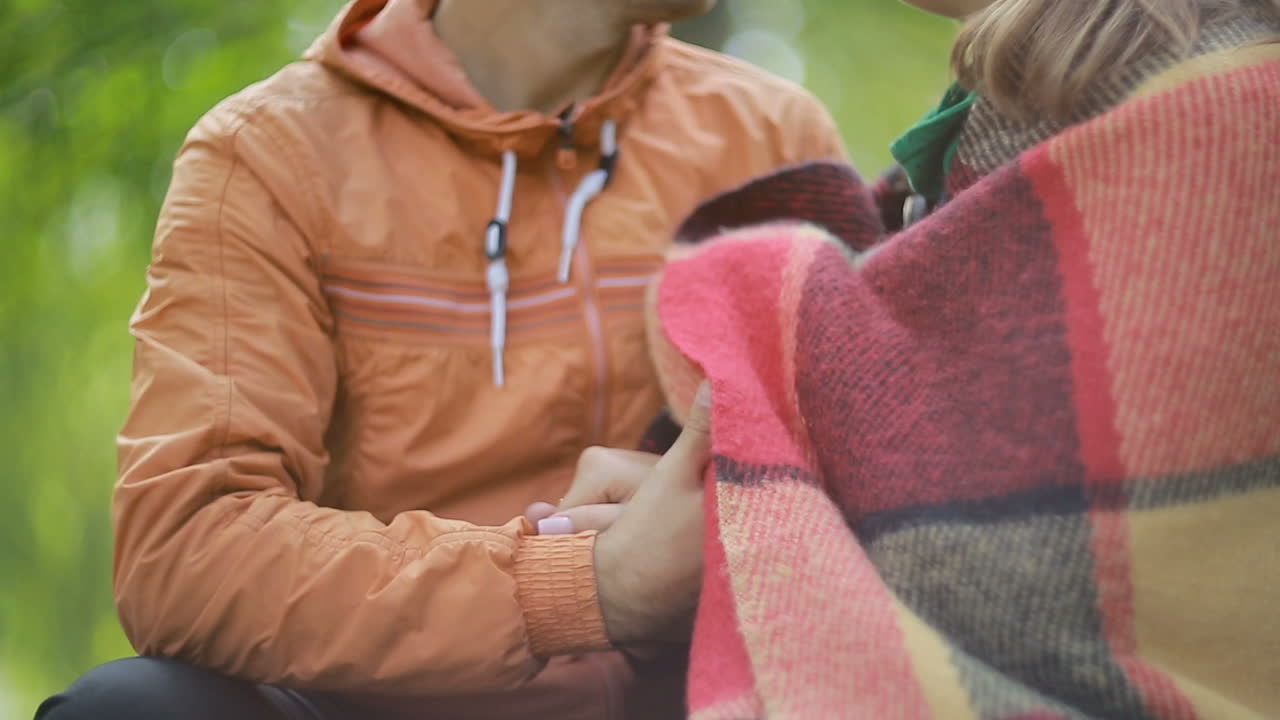 Couple In Love Sitting Togheter. Couple sitting on a bench and looking at landscape