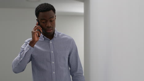 young businessman in office talking on mobile phone reacting to bad news looking unhappy and depressed 4
