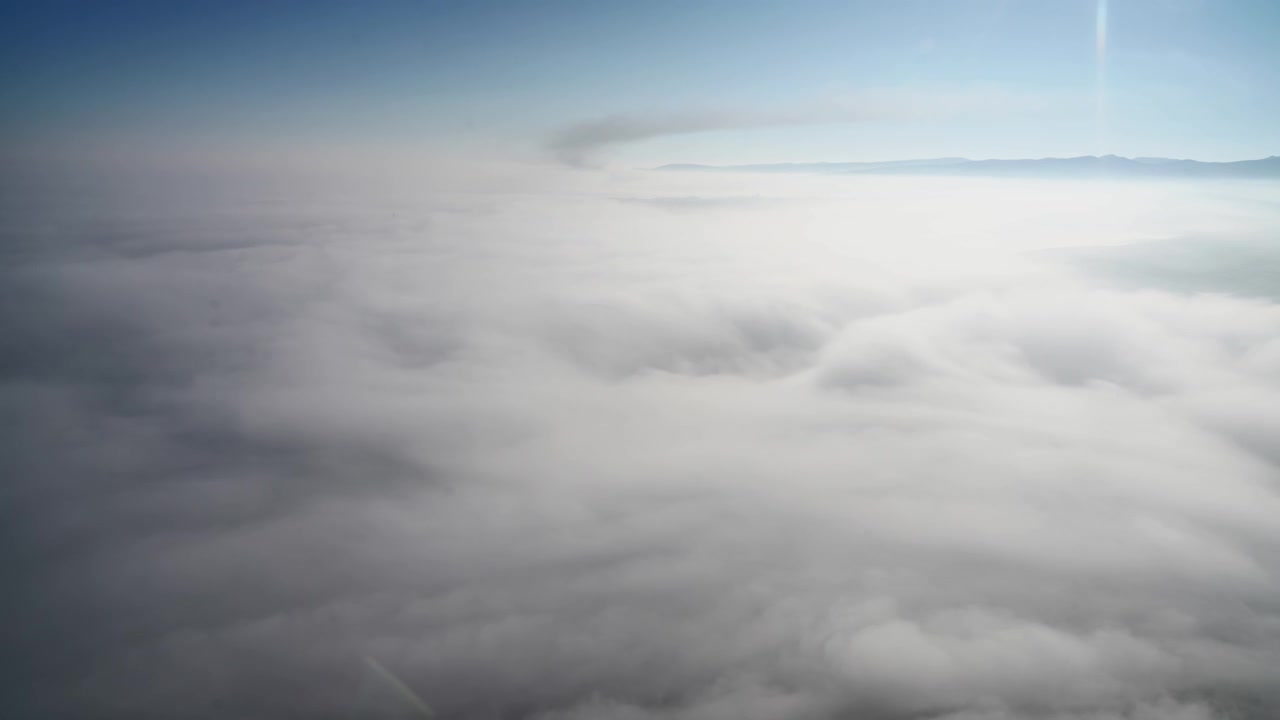 Aerial View of Thick Morning Fog Over Landscape