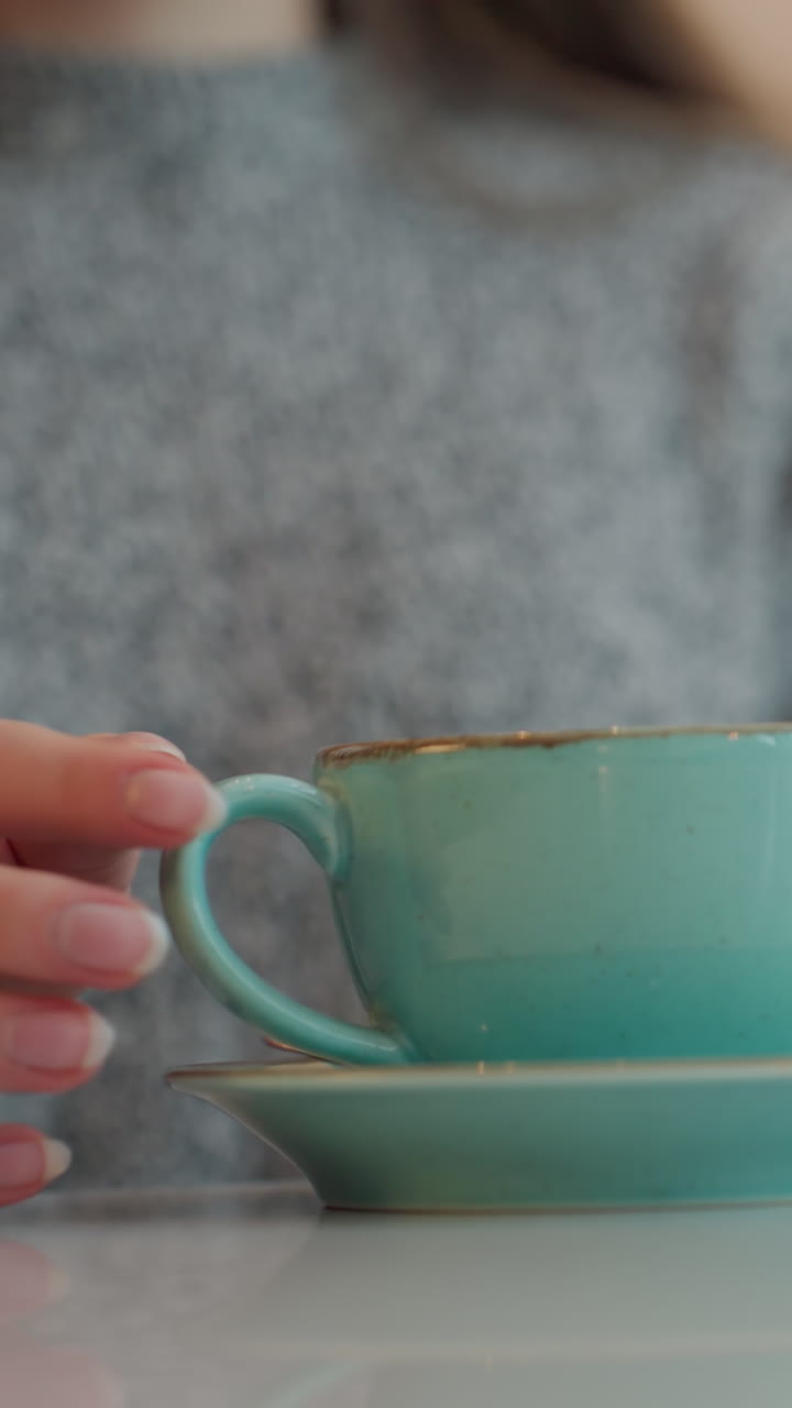 Close Perspective of Hands with Decorative Cup, Detailed View of Hands Holding Ceramic Cup in Morning Ritual, Focused Image of Light Skin Hands Gripping Elegant Teacup Before Sunrise