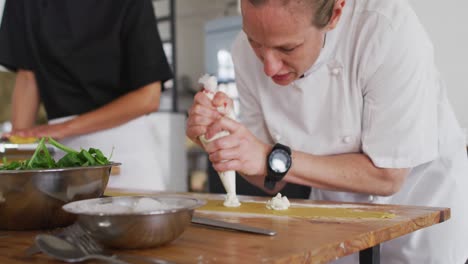 caucasian female chef teaching diverse group preparing dishes and smiling