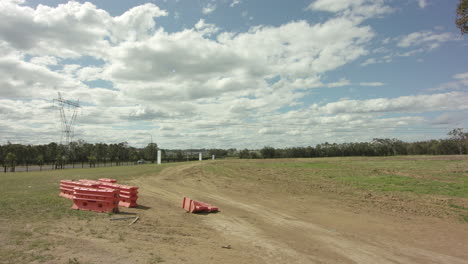 dirt road littered with orange dividers in new suburb ready for housing development