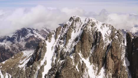 aerial circling of snow-capped cima d'asta peak in trentino