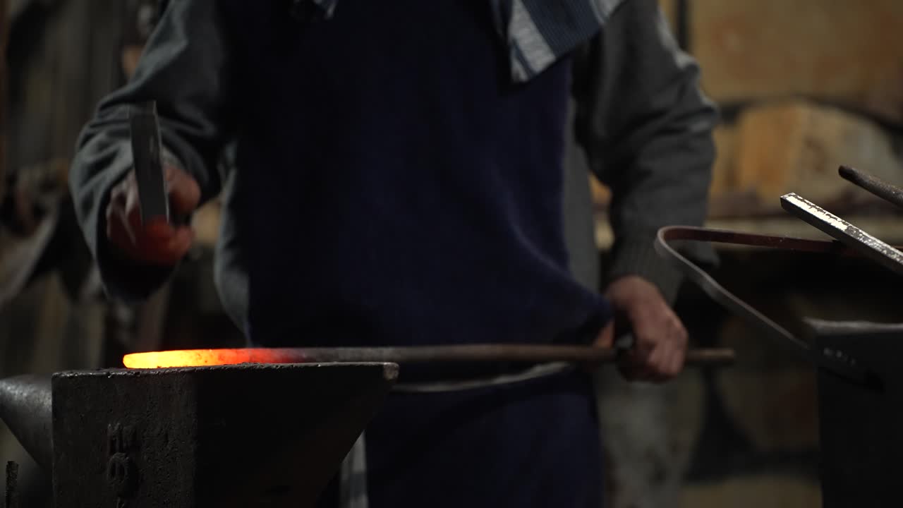 Artisanal Blacksmith Shaping Red Hot Iron in Forge for Making Tools and Weapons