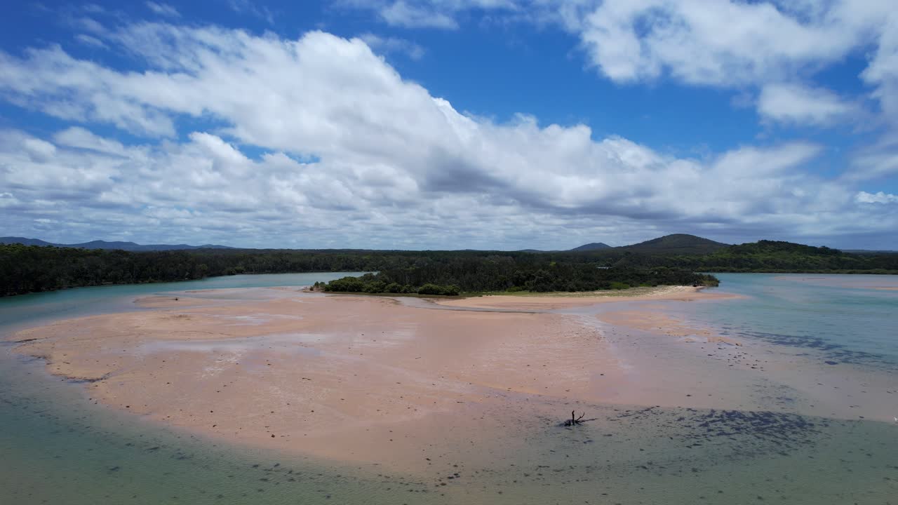 Where river meets sea, Red Rock Beach sandbank under blue skies, scenic and calm