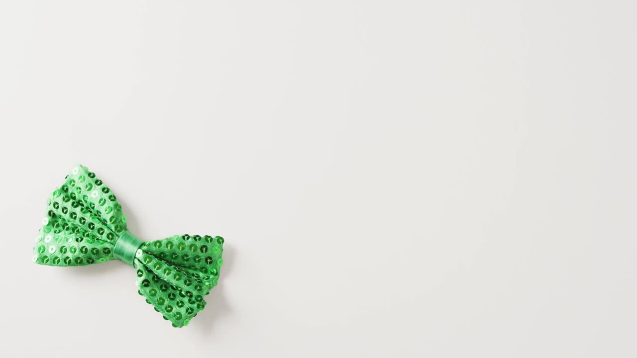Video of st patrick's green bow tie with copy space on white background