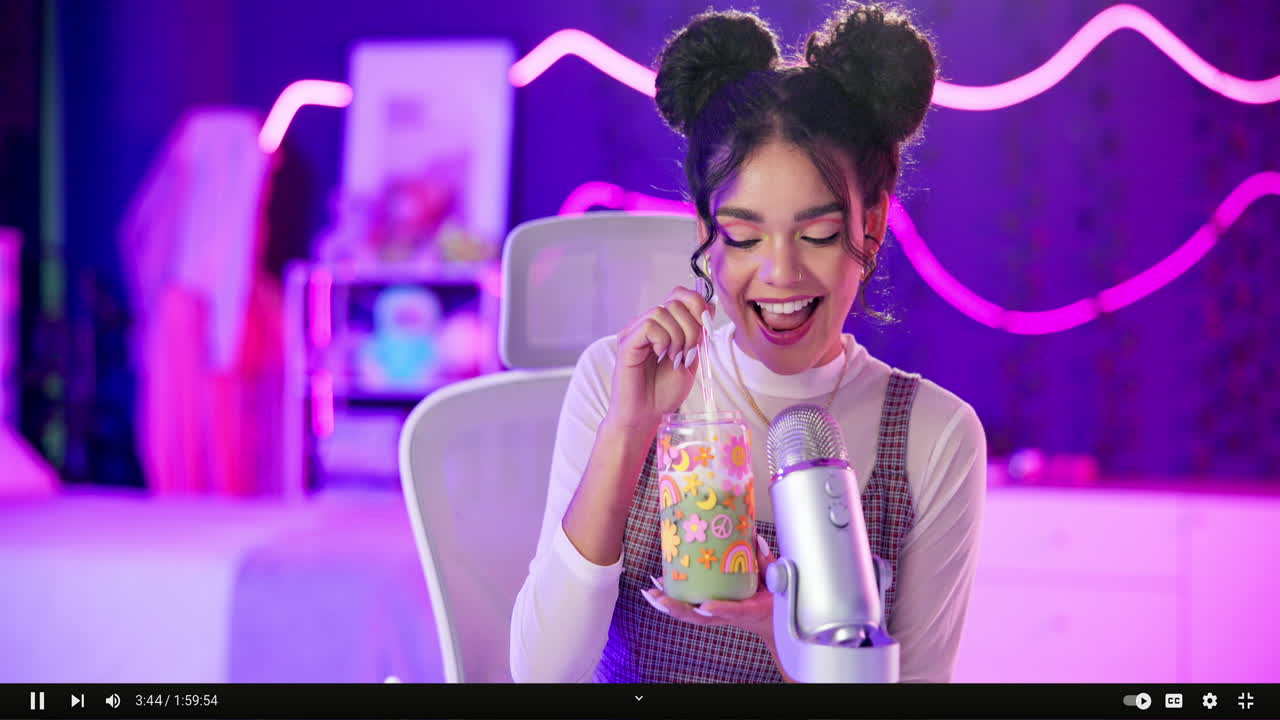 Woman streaming with microphone and drink