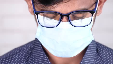 young man wearing glasses and mask