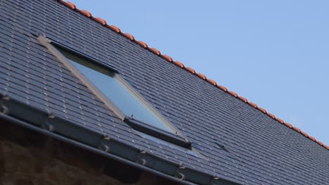 newly built slate roof tiles with single skylight window