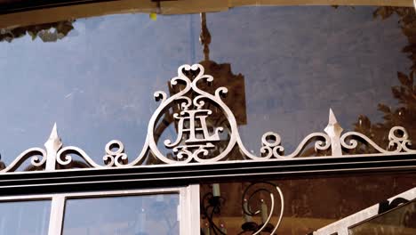 static shot of an iron coat of arms symbol above the entrance to a castle in france