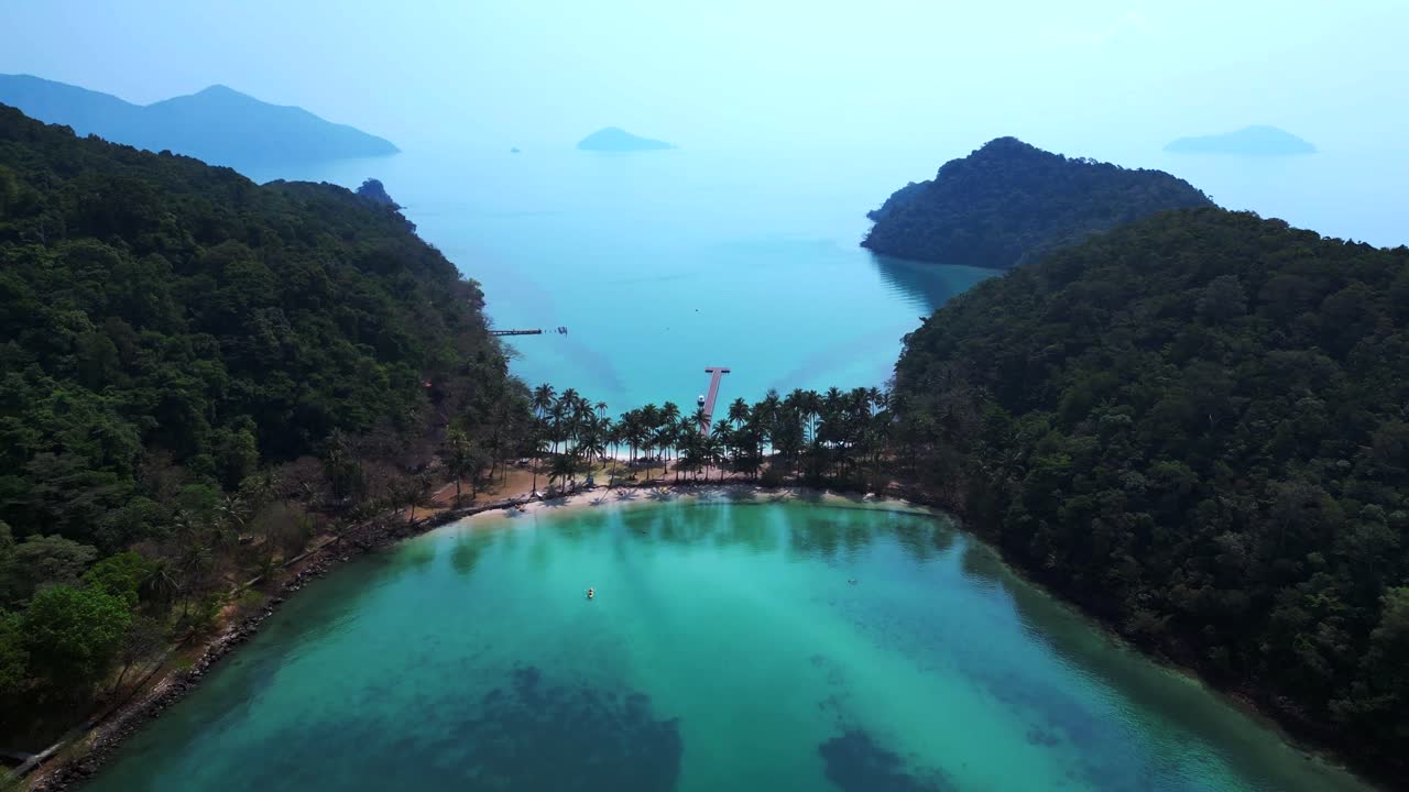 Scenic aerial view of lush green hills and turquoise waters on Koh Chang Ngam Island. overflight flyover drone