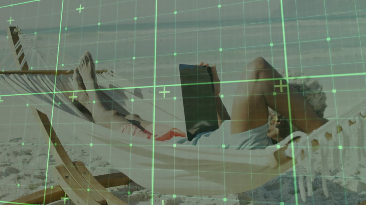 Person relaxing in hammock on beach with digital grid overlay animation