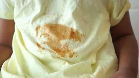 child's yellow shirt with food stain