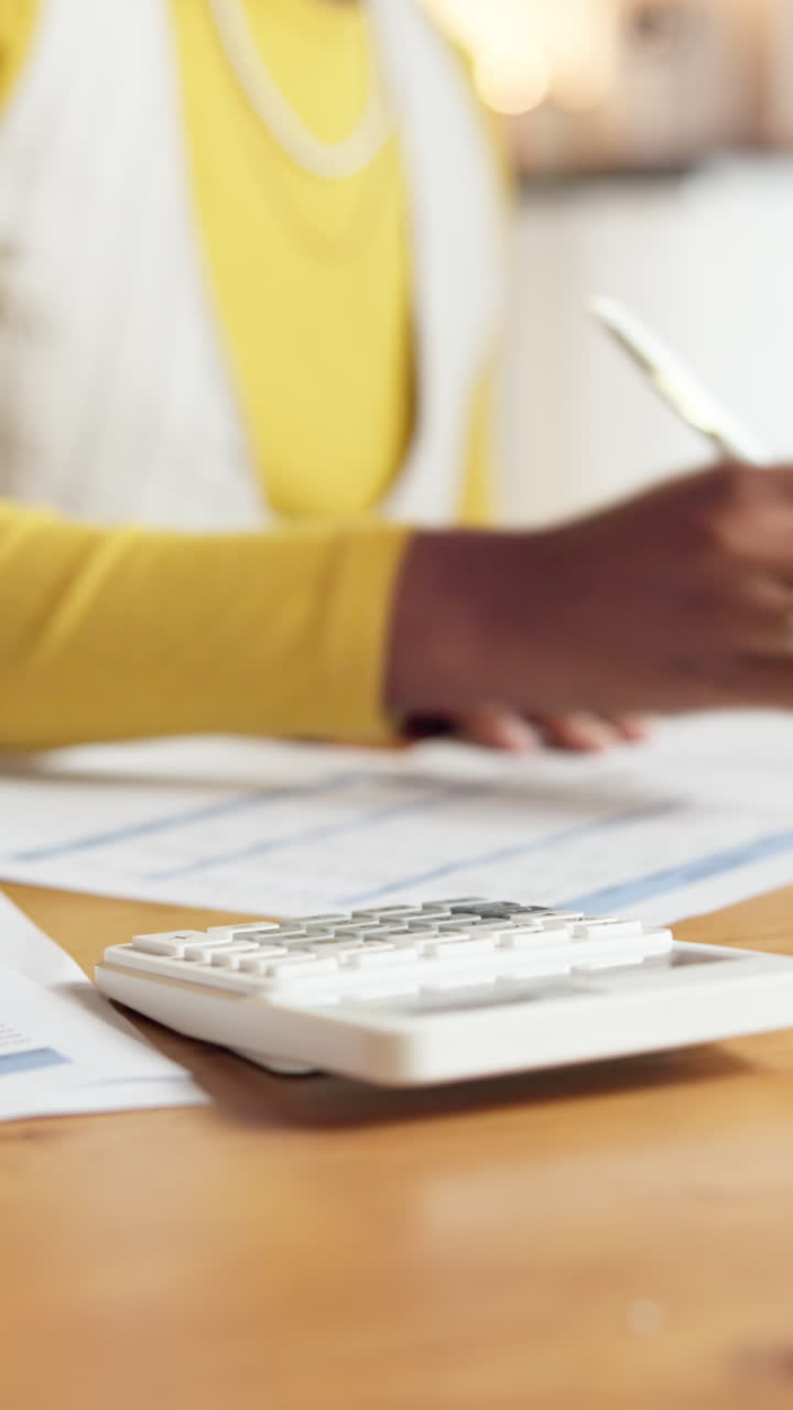 Woman working on finances with calculator and paperwork