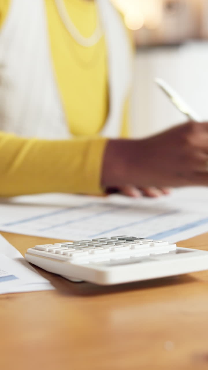 Woman working on finances with calculator and paperwork