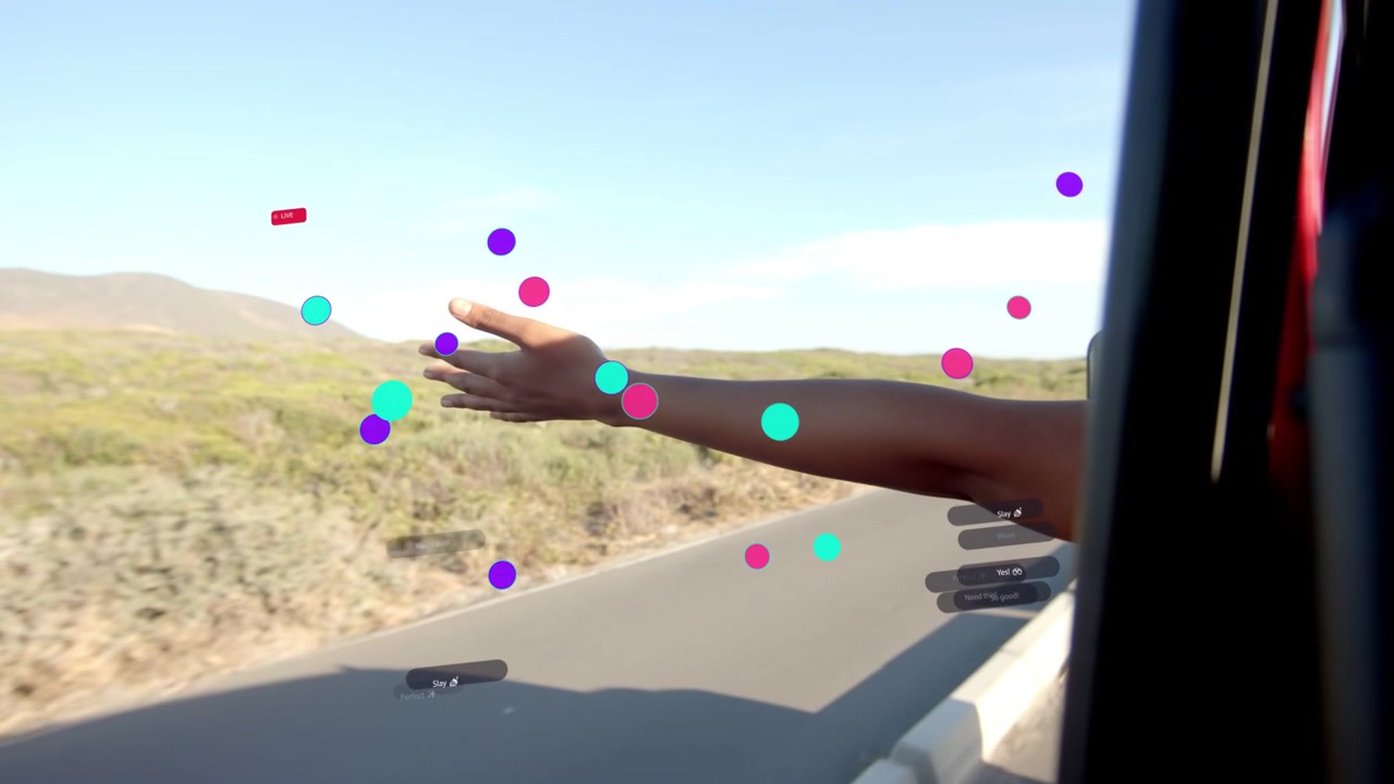 Female passenger reaching out through car window, sweeping hand over road, using tech overlays
