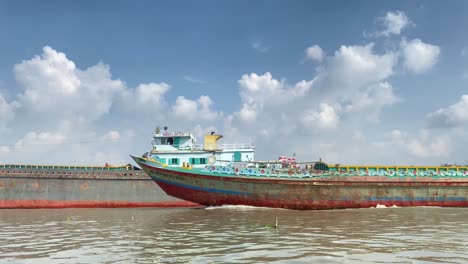 static shot of large cargo ship sailing in buriganga river, dhaka, bangladesh