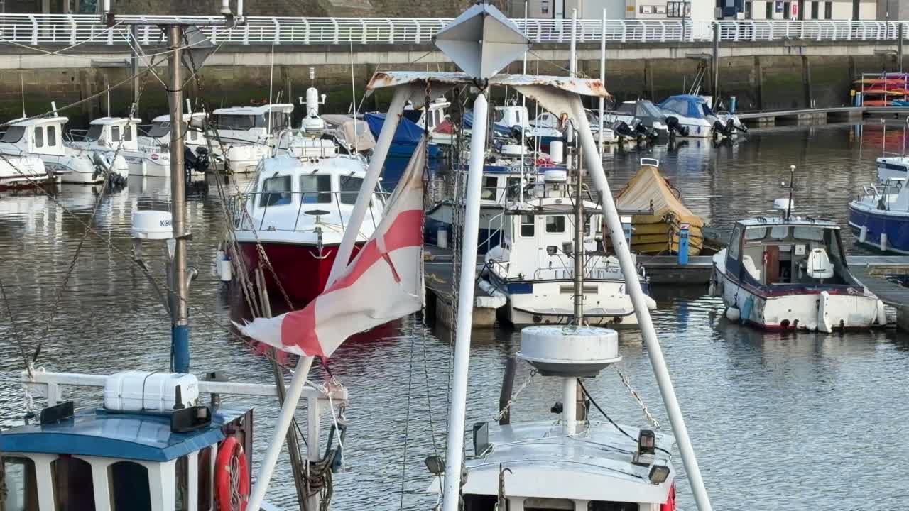 England st George's cross english flag on a boat in the marina blowing in the wind