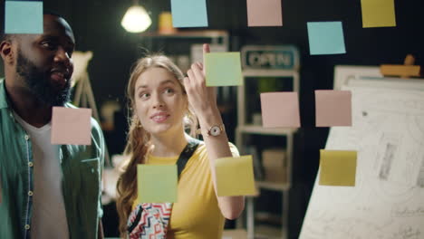 closeup friendly mixed race couple discussing project in night office