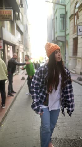 young woman walking down a city street