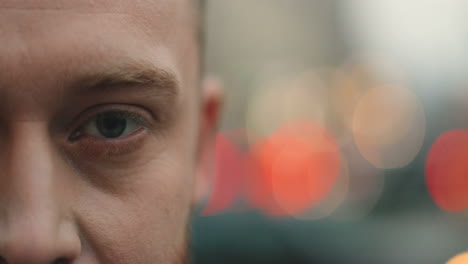 Close-up-view-of-Half-face-portrait-of-Caucasian-businessman-with-a-beard-smiling-to-the-camera-cheerfully-in-the-street-in-autumn