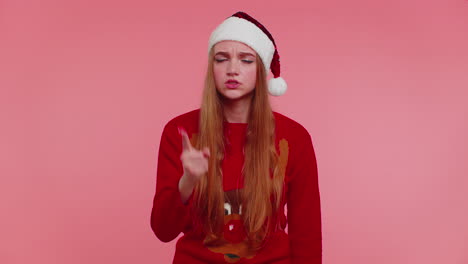 Displeased-girl-in-Christmas-sweater-gesturing-hands-with-displeasure,-blaming-scolding-for-failure