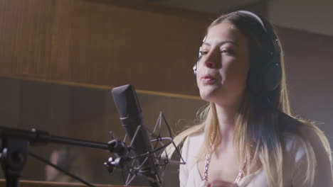 beautiful female singer working in music studio