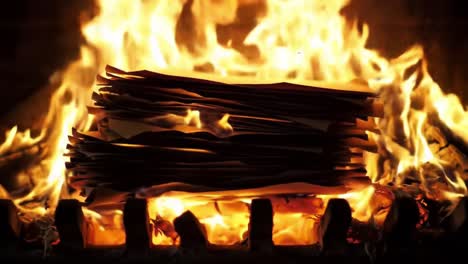 a fiery transformation: the intense blaze consuming stacked papers, highlighting the raw power of fire and its ability to destroy and transform material into ash