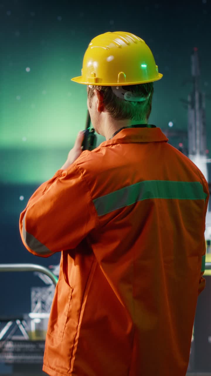 Vertical Video Worker communicates via radio stations on offshore oil platform