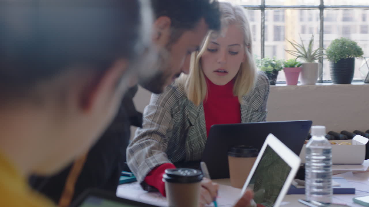 creative team of engineers using tablet computer designing bicycle prototype viewing 3d design on screen planning project sharing ideas in office meeting