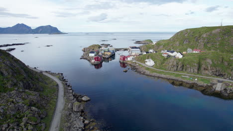 aerial descending shot of a norwegian historical fishing village, calm nice summer day, nyksund, northern norway