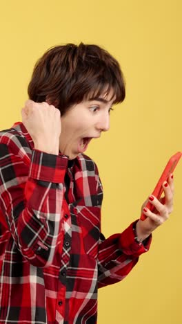 excited young woman reacting to good news on her smartphone