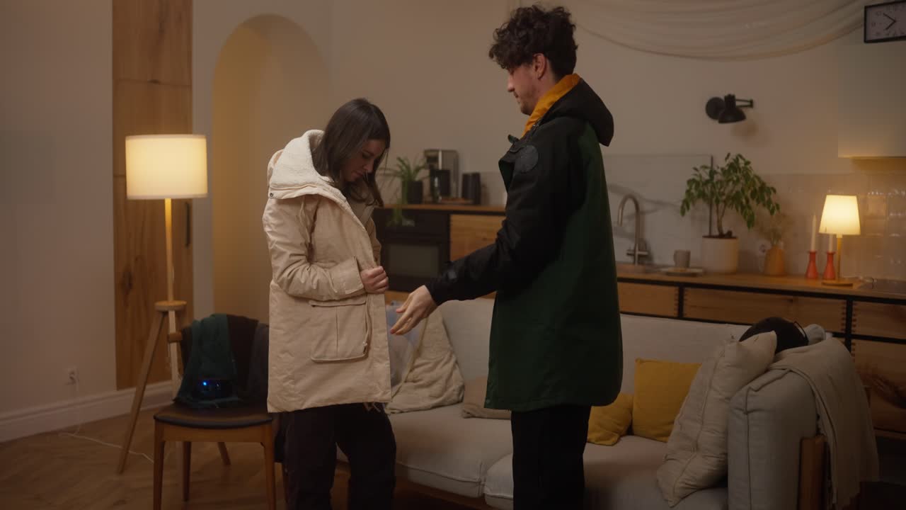 Couple Getting Dressed in Warm Jackets at Home