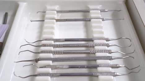 close-up of sterilised dentist's instruments for working on teeth arranged on medical cabinet