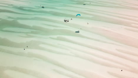aerial view of sandbanks and kite surfers in shallow waters