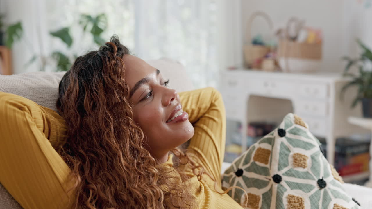 A woman relaxing on a couch at home