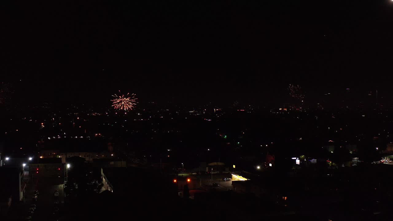 Aerial panning shot of illegal fireworks across Los Angeles. 4K